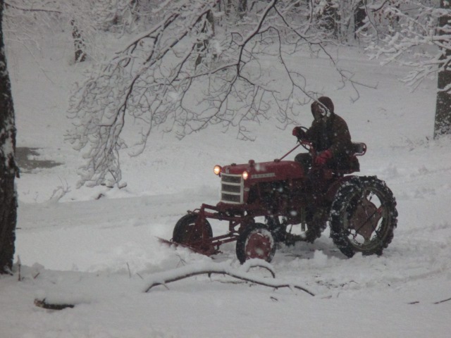 image of a tractor plowing snow off the driveway